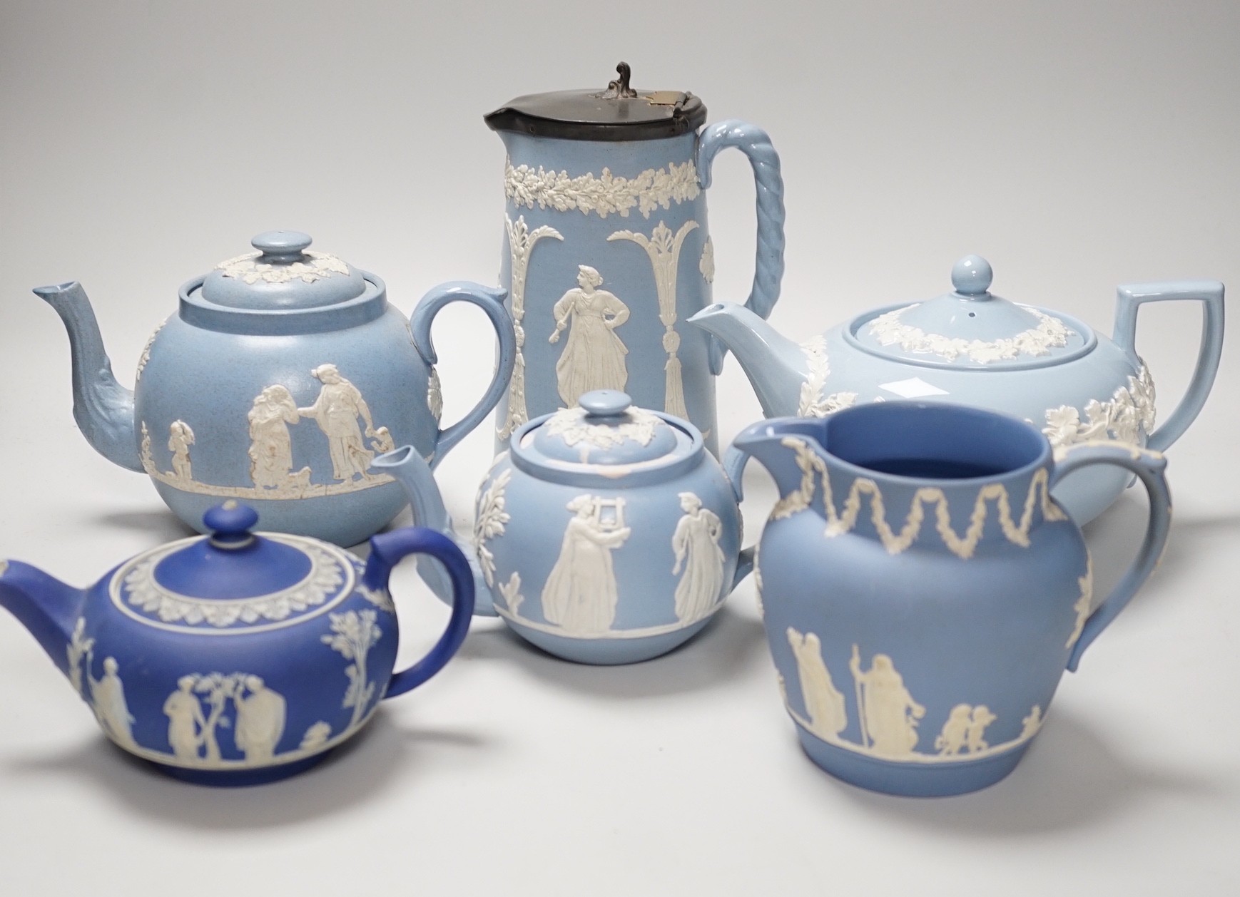 A group of Wedgwood and Wedgwood-style jasperware teapots and jugs.